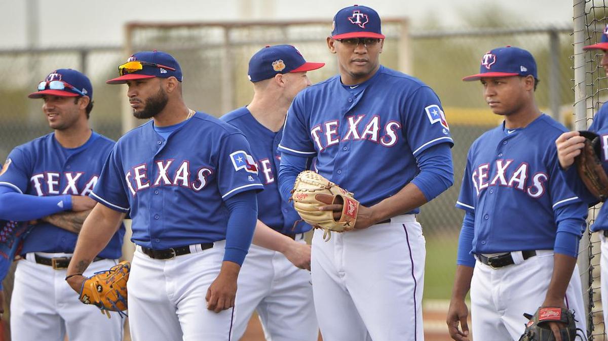 Rangers pitchers Matt Bush, left, Dario Alvarez, Jose Valdespina and Jose Leclerc lineup for pick-off drill Wednesday morning in Surprise, Ariz.