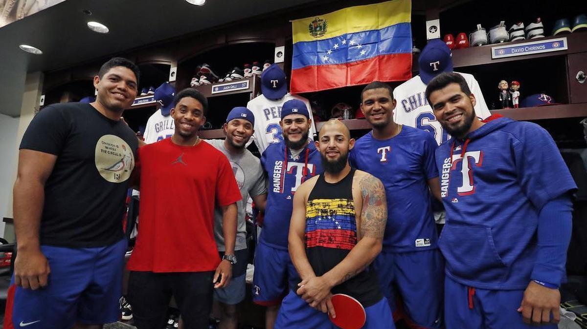 In the Rangers clubhouse with their country's flag behind them, Ricardo Rodriguez, Elvis’ brother Erikson Andrus, Elvis Andrus, Martín Pérez, Rougned Odor, Yohander Mendez and Robinson Chirinos. Most of the Venezuelan players on the Texas Rangers have brought their family members to the U.S. to escape the chaos going on in their home country.
