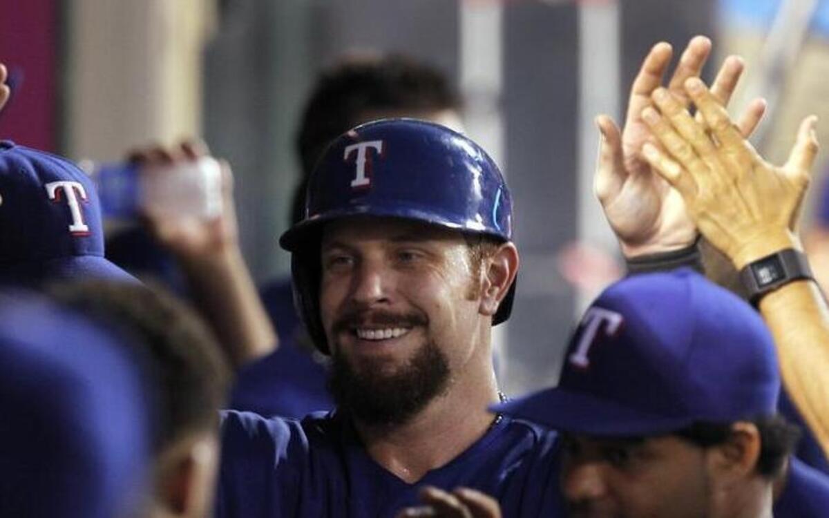 
Josh Hamilton is greeted by his teammates in the fifth inning after a double and a run scored.
