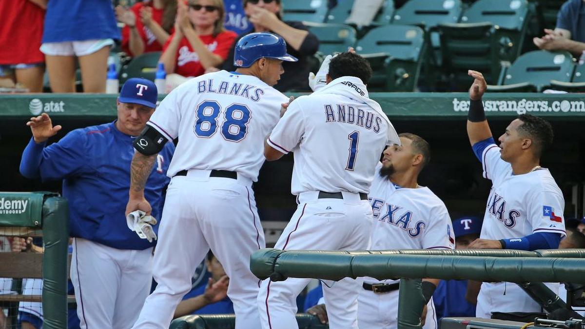 
Rangers first baseman Kyle Blanks is greeted in the dugout by manager Jeff Bannister, left, and teammates after his second inning solo home run gave Texas a 1-0 lead.
