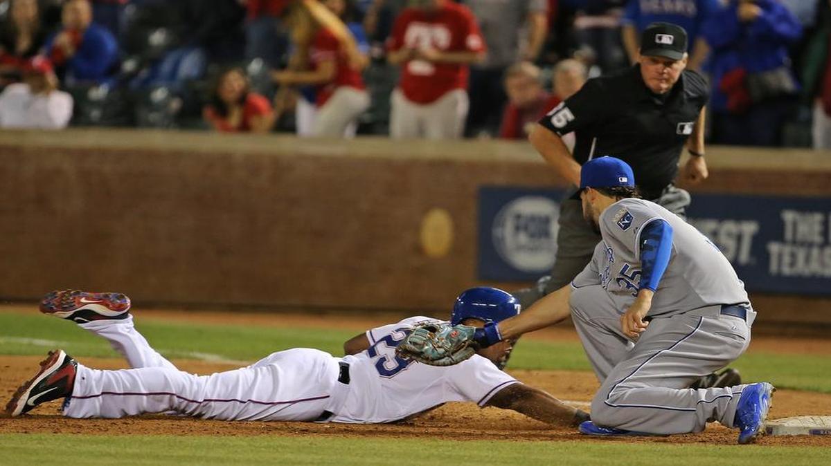 
Rangers third baseman Adrian Beltre dives back to first as Kansas City Royals first baseman Eric Hosmer makes the tag. Beltre was ruled safe, but after a review it was overturned to end the ninth. The Royals beat the Rangers 7-6 in 10 innings Tuesday.
