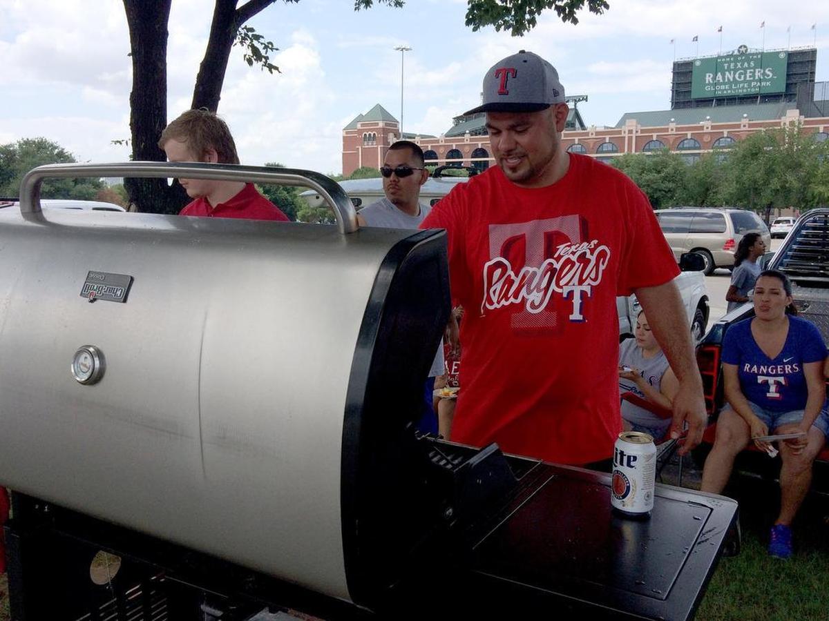 Globe Life Park parking lots open three hours before game time, making them a perfect spot for tailgating. Lance Patton of Irving was grilling some short ribs before a recent Rangers game. 