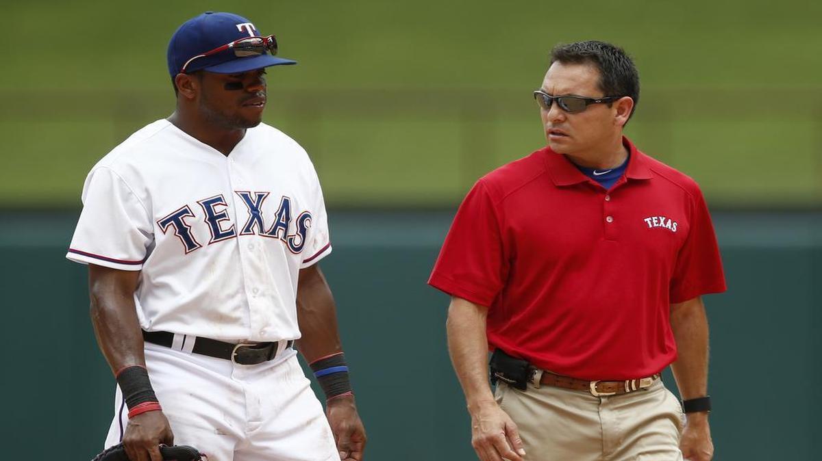 
Rangers’ Delino DeShields, left, leaves a baseball game with trainer Matt Lucero after an injury while chasing a triple hit by the Twins’ Shane Robinson in the sixth inning Sunday.
