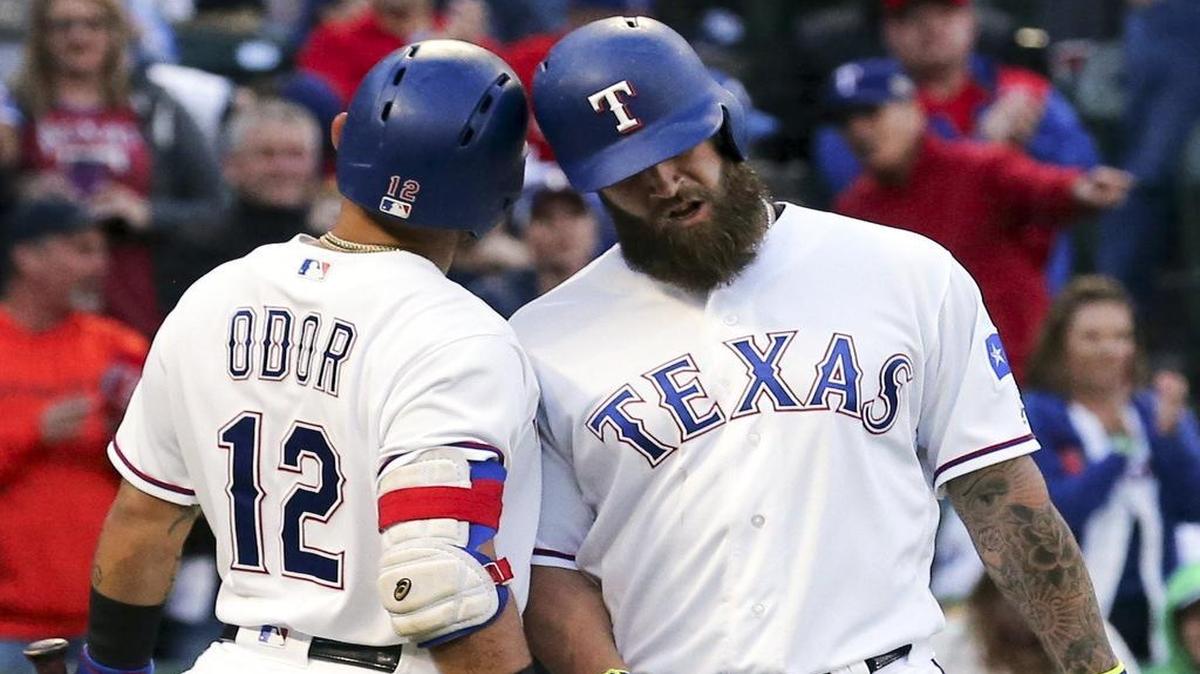 Rangers Rougned Odor, left, and Mike Napoli bump helmets after Napoli homered in the second inning Saturday night against the Royals.