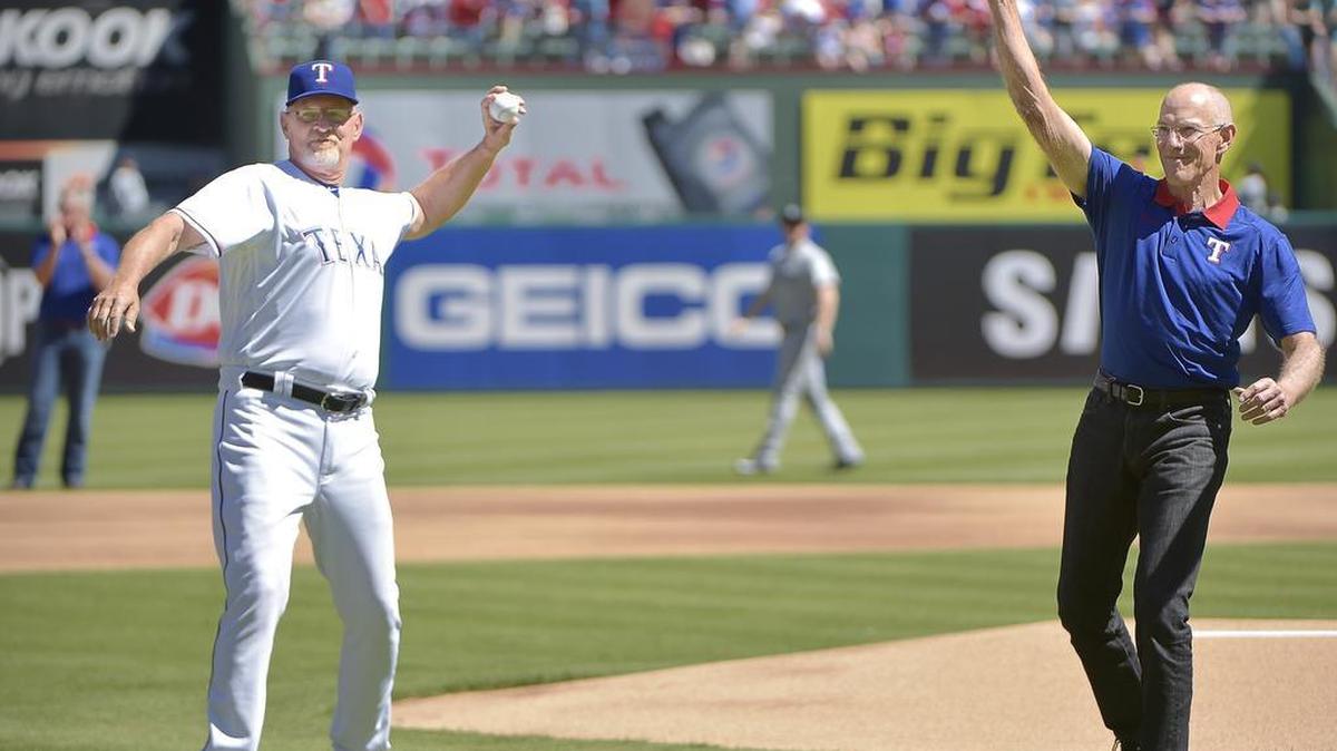 Bobby Jones, left, and Tom Grieve throw out ceremonial first pitches before the Rangers’ opening game. The friends and former teammates have spent 50 years in baseball.