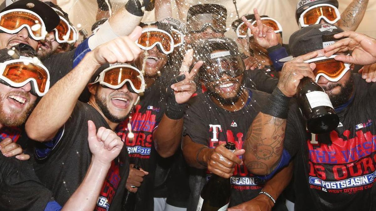 
Texas Rangers teammates celebrate in the clubhouse following their 9-2 win over the Los Angeles Angels. The Rangers clinched the American League West division.

