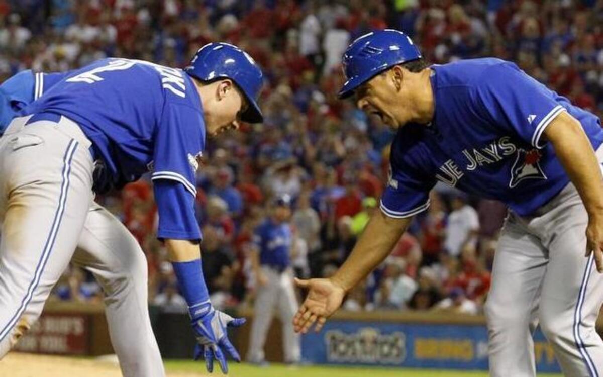 
Toronto shortstop Troy Tulowitzki and third-base coach Luis Rivera exchanged low-fives after a three-run homer in the sixth inning of a 5-1 Blue Jays win.
