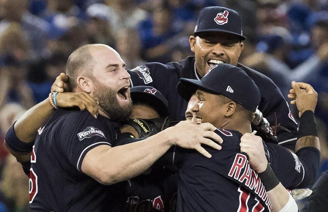 Former Ranger Mike Napoli, left, celebrates with his Indians teammates Coco Crisp, top, and Jose Ramirez, bottom right, after clinching the American League pennant on Oct. 19.