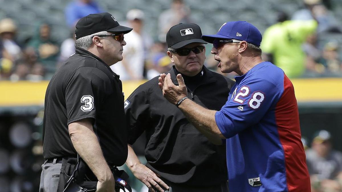 Rangers manager Jeff Banister (28) argues with umpires Tim Welke (3) and Mike Everitt after being ejected during the third inning of Wednesday’s 9-1 loss to the Oakland A’s at Oakland Coliseum.