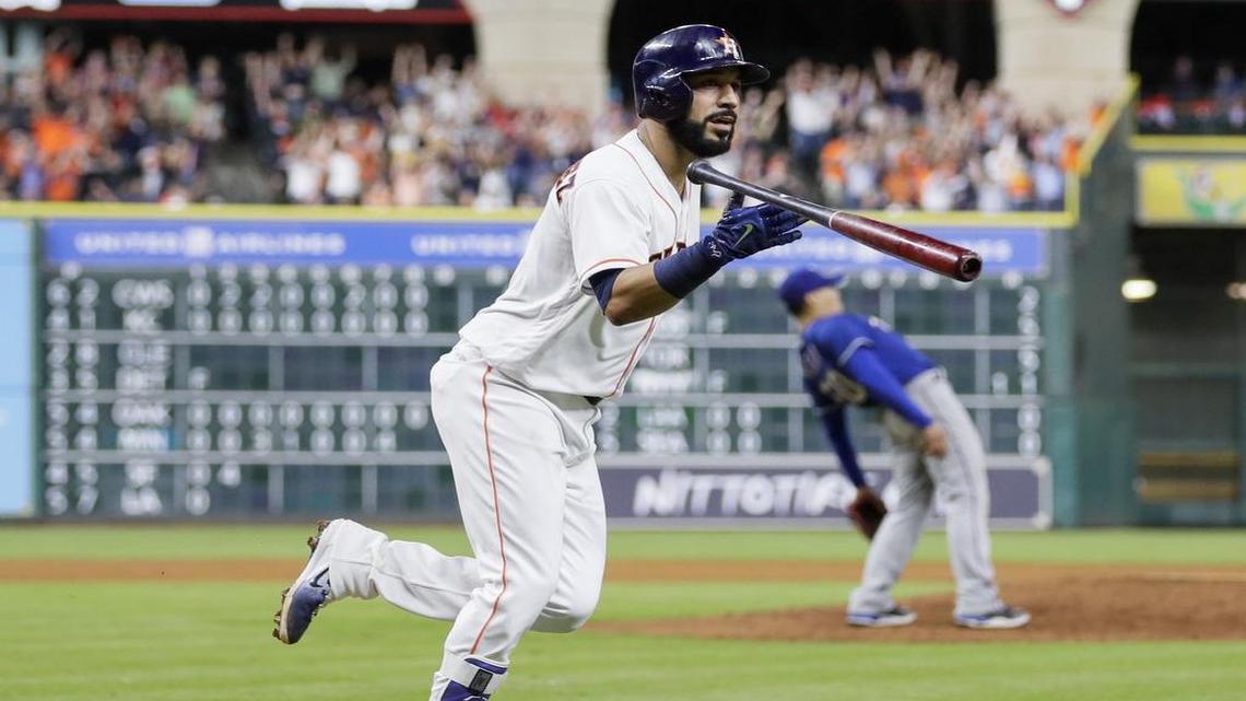 Marwin Gonzalez tosses his bat after hitting a grand slam off Rangers’ reliever Keone Kela, right, in the eighth inning Tuesday night at Minute Maid Park. The Astros won 8-7.
