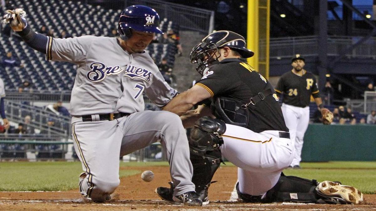 The Rangers signed catcher Michael McKenry, right with the Brewers’ Brewers’ Norichika Aoki. McKenry has seen major league action in each of the past six seasons with the Colorado Rockies and Pittsburgh Pirates.