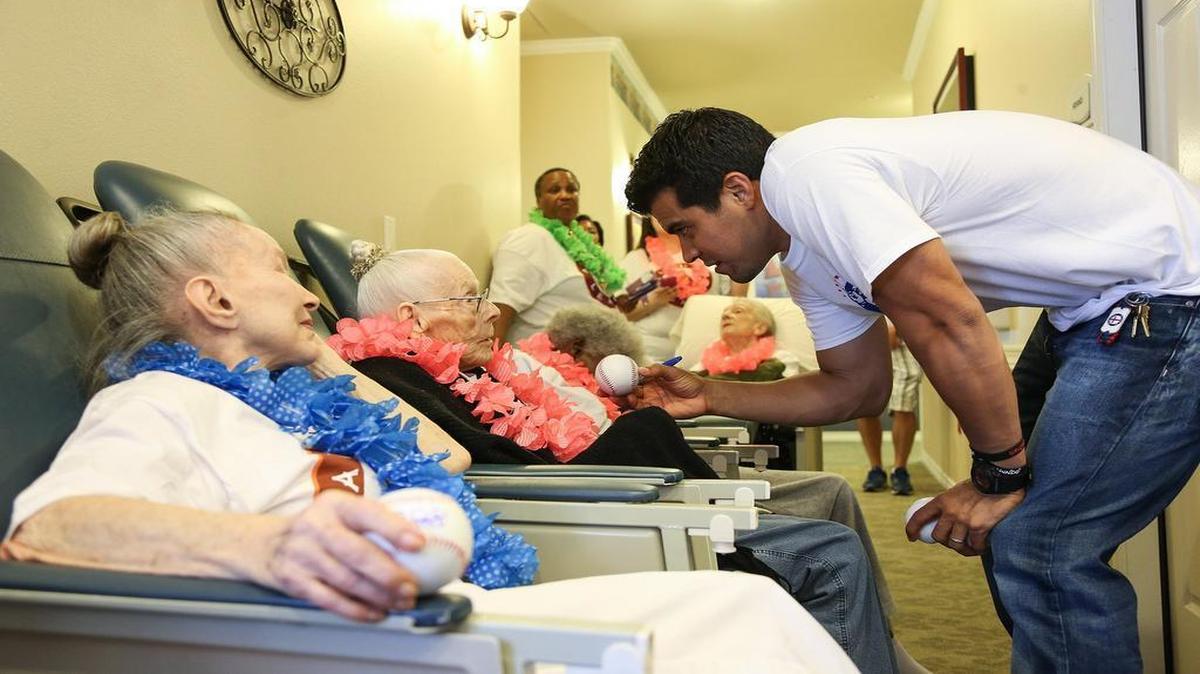 Rangers catcher Robinson Chirinos visited with seniors at the Wedgewood Nursing Home in Fort Worth in December.