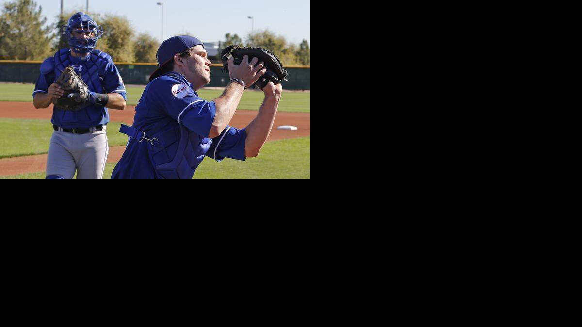 
Rangers catcher Patrick Cantwell catches a pop fly during spring training workouts.
