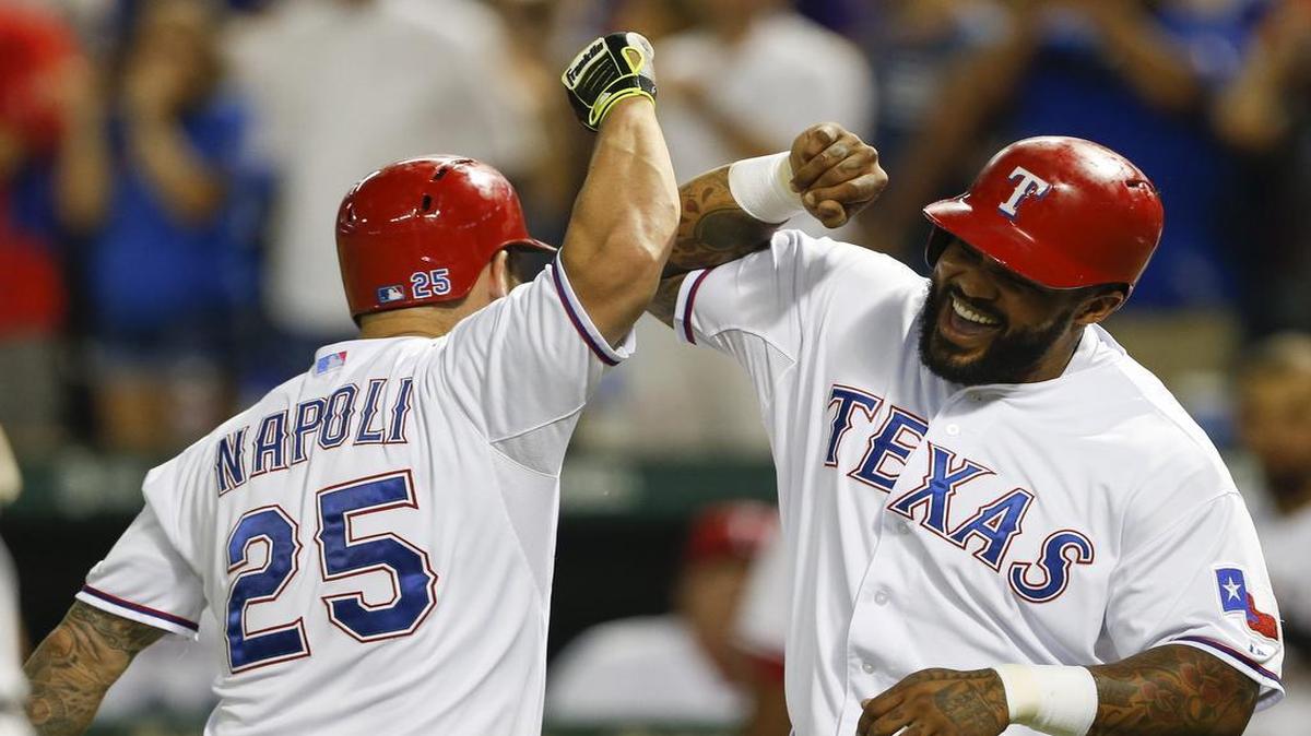 
Rangers’ Mike Napoli celebrates his two-run home run with Prince Fielder in the third inning Wednesday. Texas beat Detroit 6-2 to drop the Rangers’ magic number to three.
