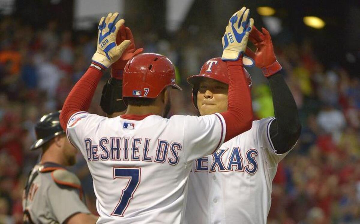 
Delino DeShields celebrates with Shin-Soo Choo after Choo's first-inning two-run homer. The Rangers beat the Tigers 7-6 Tuesday night at Globe Life Park.
