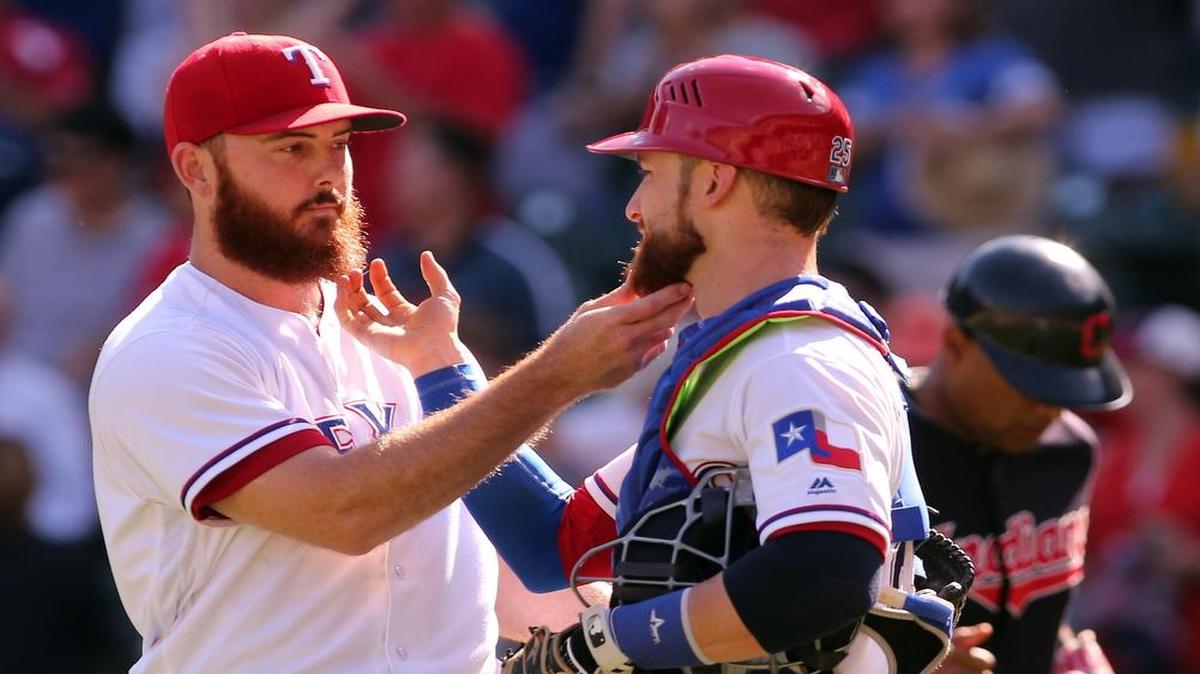 Sam Dyson, left, loaded the bases before preserving the Rangers’ 2-1 win Sunday against the Indians to earn his 29th save. He and catcher Jonathan Lucroy like to rub beards after each win.
