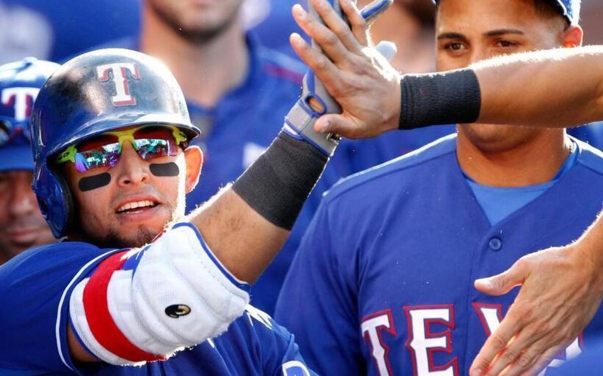 
Texas Rangers’ Rougned Odor, center, gets congratulations from teammates for hitting a solo home run against the Los Angeles Angels during the first inning of a baseball game in Anaheim, Calif., Saturday, July 25, 2015. 
