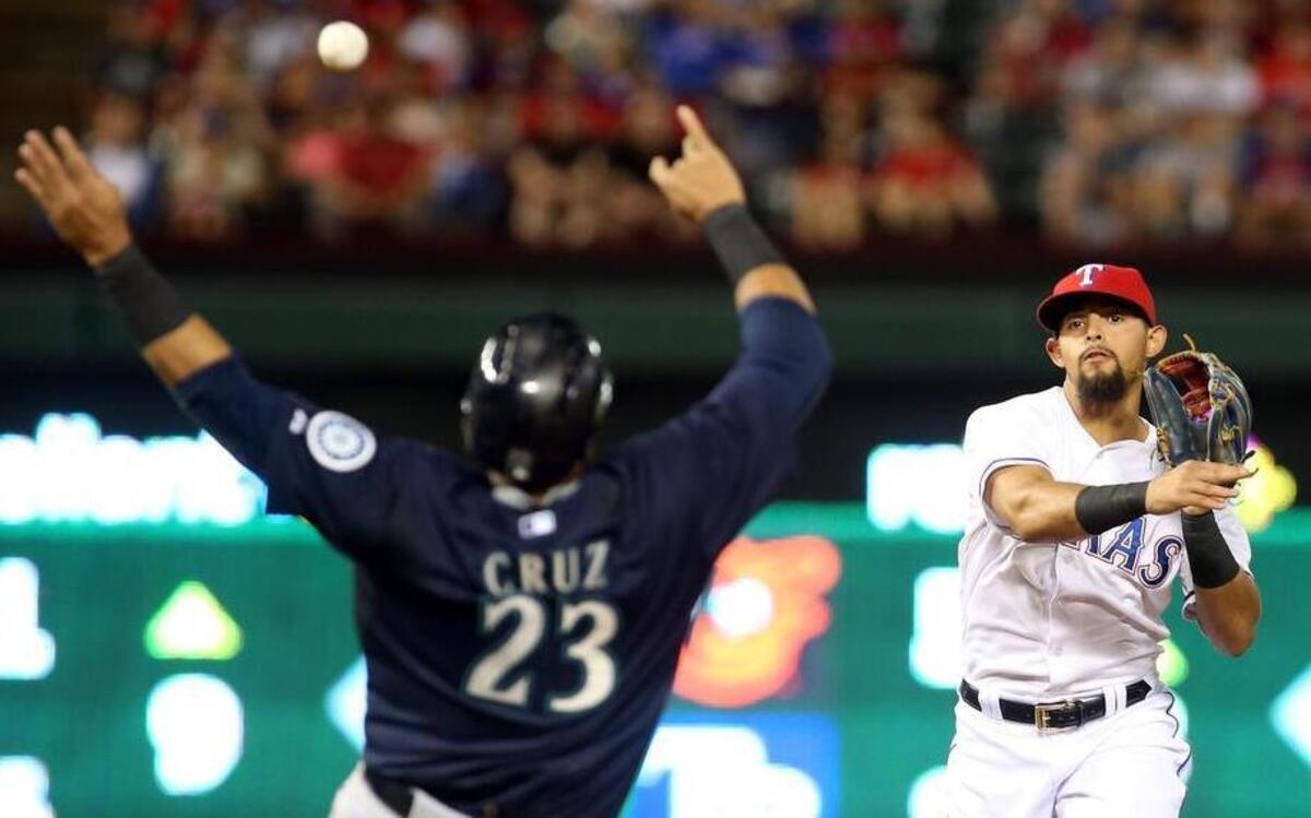
Seattle Mariners Nelson Cruz (23) is forced out at second as Texas Rangers second baseman Rougned Odor (12) turns the double play in the fifth inning 
