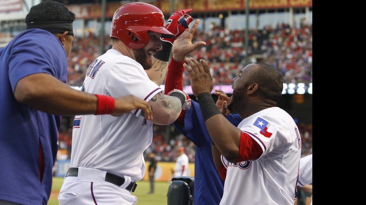 
Josh Hamilton is congratulated by Rangers teammates after his second solo home run in the fourth inning.
