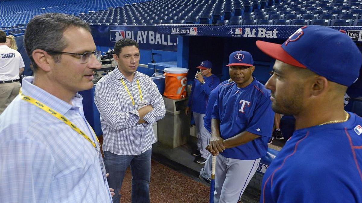 Rangers assistant general manager Thad Levine, left, and general manager Jon Daniels, second from left, talk with third base coach Tony Beasley and Ian Desmond before a game in Toronto this month. Levine is reportedly the top candidate for the Minnesota Twins’ GM job.