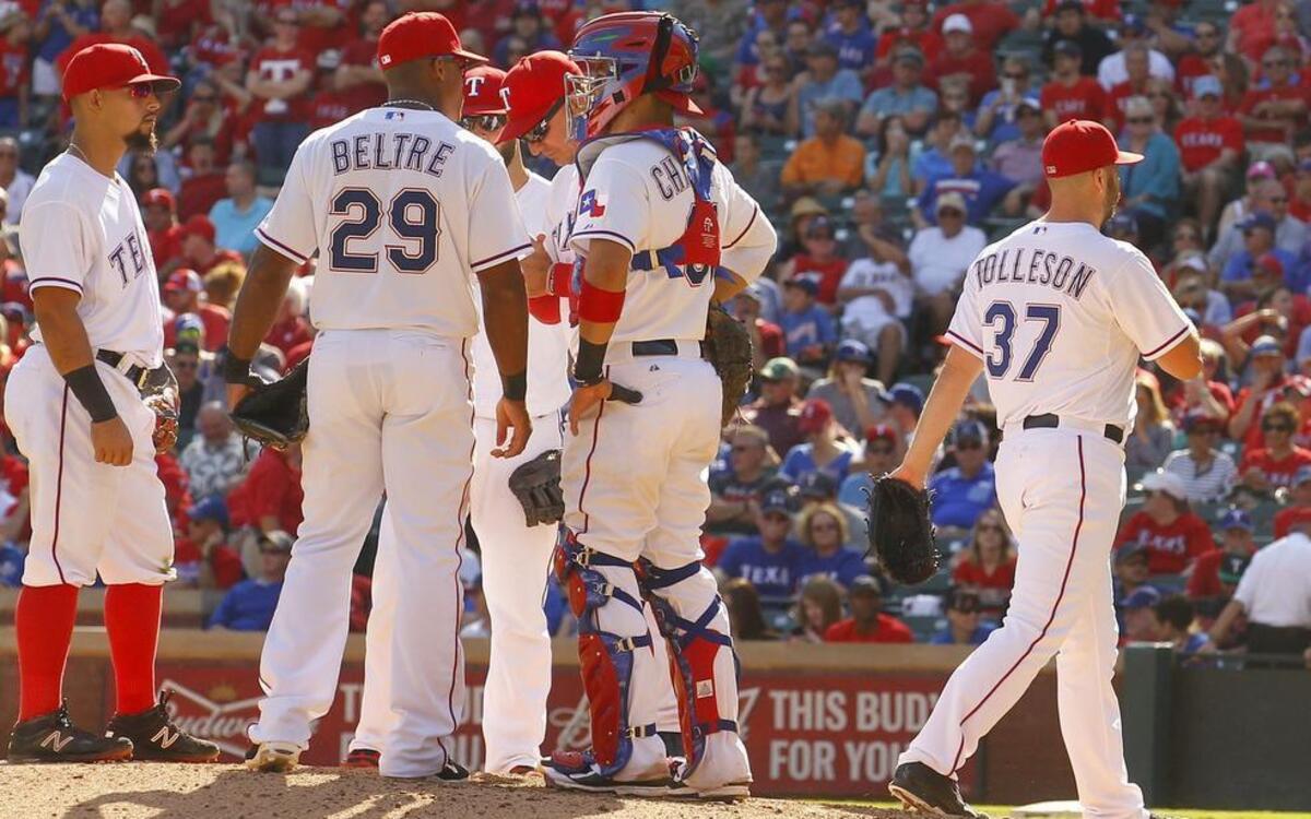 
Rangers closer Shawn Tolleson, right, leaves the game in the ninth inning after giving up two home runs against the Angels at Globe Life Park on Saturday afternoon. The Angels scored five runs in the inning to stun the Rangers 11-10.
