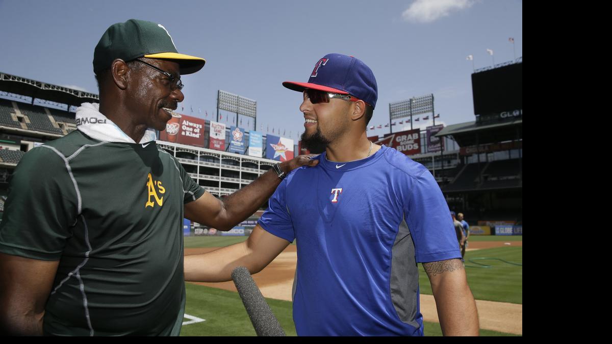 
Athletics fielding coach Ron Washington, left, visits with Rangers second baseman Rougned Odor during batting practice before Tuesday’s game. It was Washington’s first game back at Globe Life Park since leaving the Texas organization last September.
