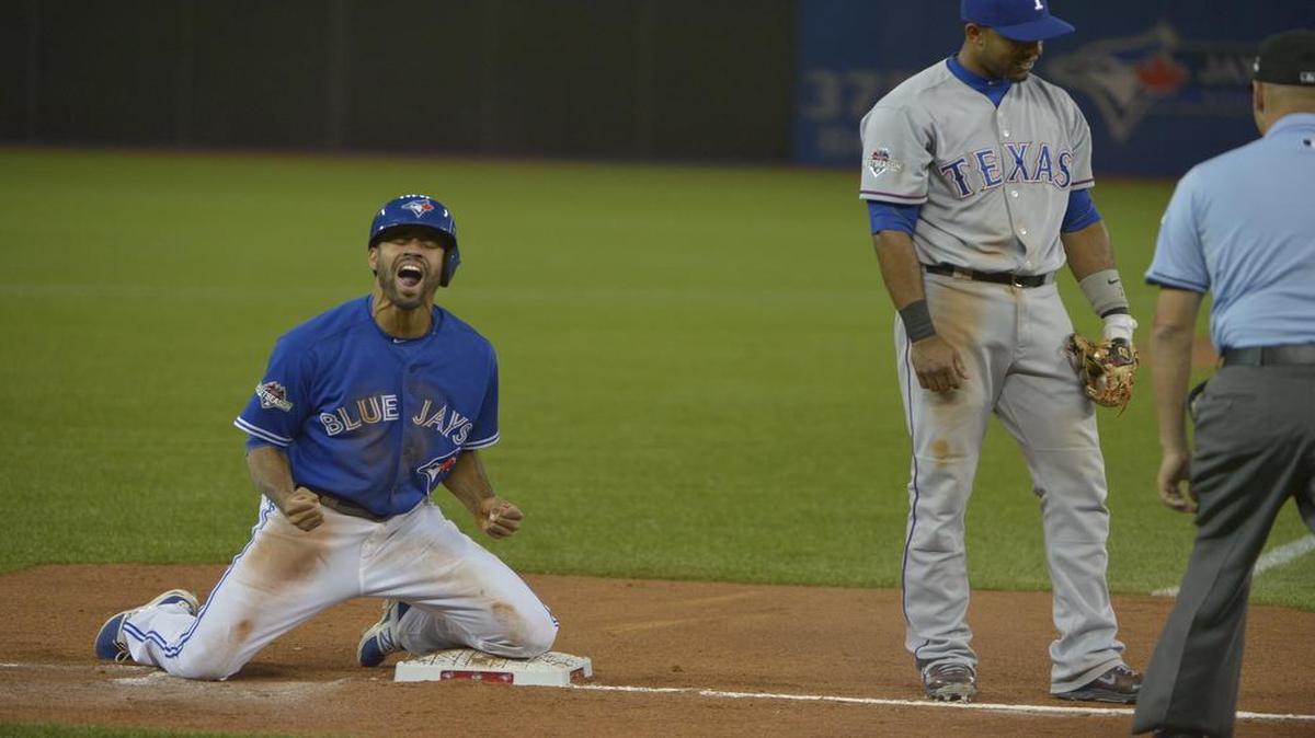 
Blue Jays pinch-runner Dalton Pompey is safe at third in the seventh inning when Rangers shortstop Elvis Andrus dropped a throw from Adrian Beltte. It was Andrus’ second error of the game. Toronto scored four runs in the seventh and beat Texas 6-3 to claim the ALDS.

