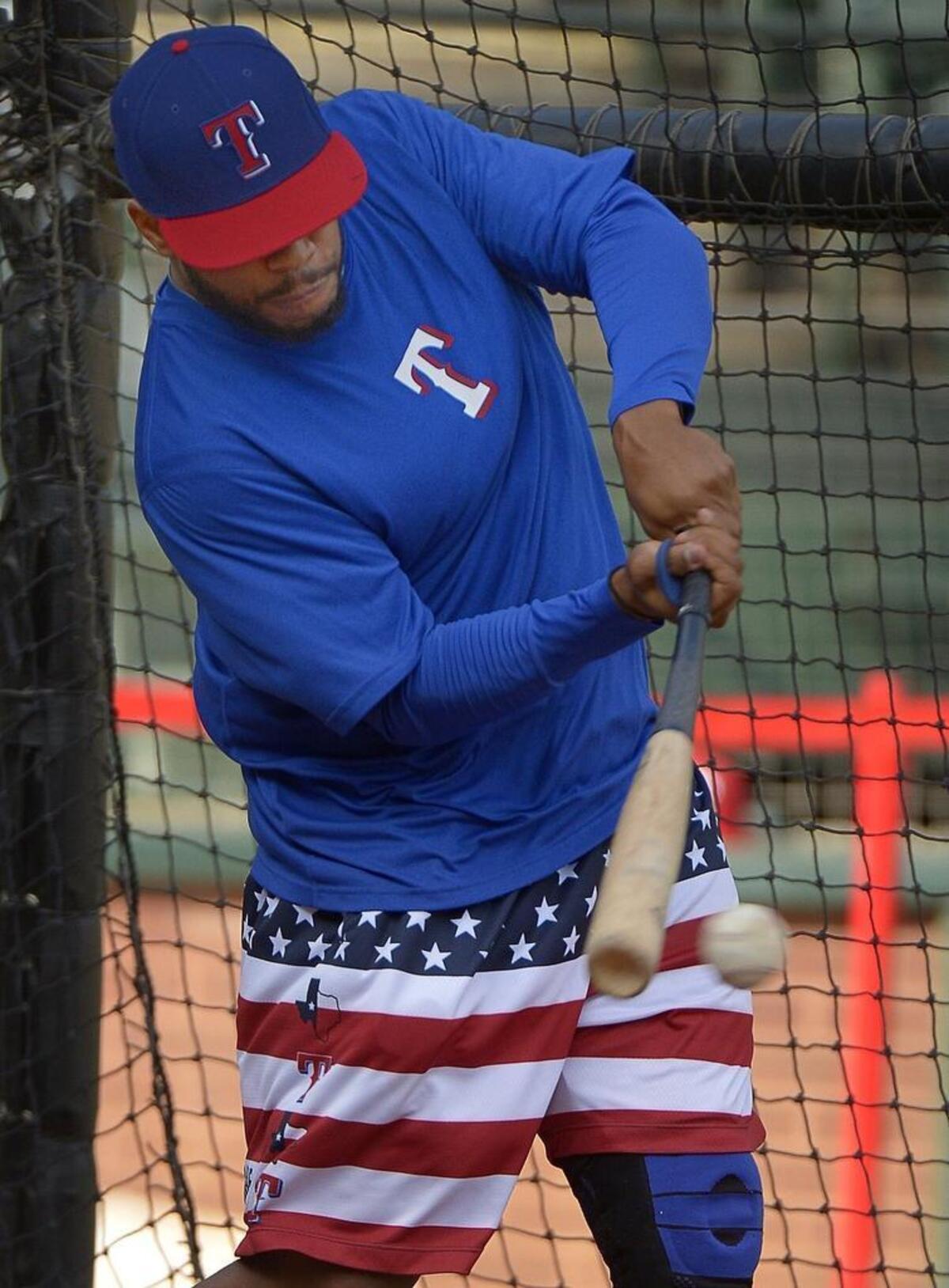 Rangers center fielder Delino DeShields wears the Never Ever Quit shorts during batting practice Tuesday. The Rangers are selling the shorts for $65 at the Globe Life Park gift shop.