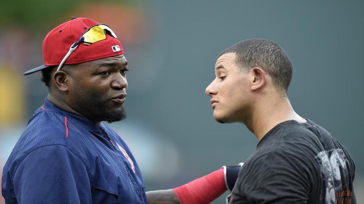 Red Sox slugger David Ortiz, left, talks with the Orioles’ Manny Machado before a game. The two ar predicted to meet in the American League wild card game with the winner playing the Rangers in the ALDS.
