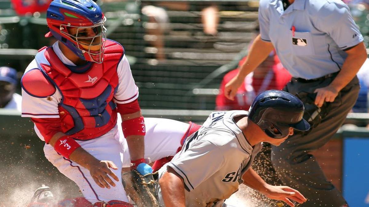 
Texas Rangers catcher Carlos Corporan tries to make the tag without the ball as San Diego Padres’ Will Venable scores in the second inning at Globe Life Park in Arlington Sunday, July 12, 2015 
