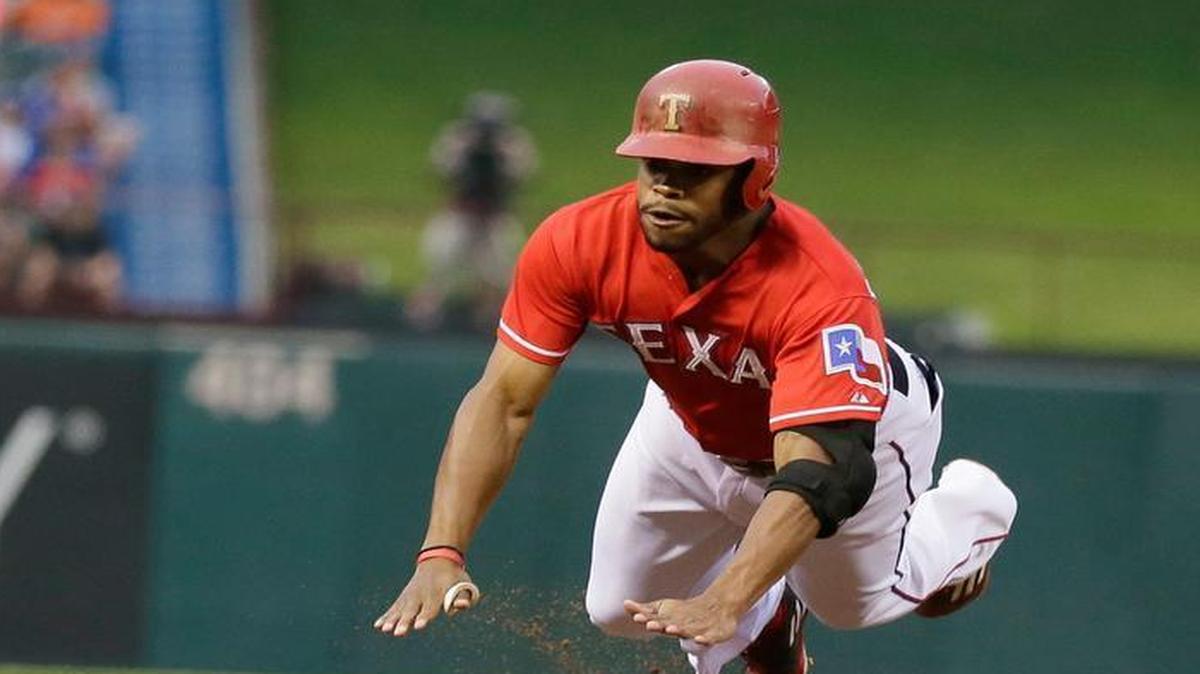 
Delino DeShields slides head first into third base as he opened the game with a triple. DeShields was later thrown out in a rundown.


