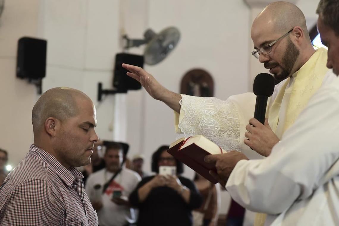 Pudge Rodriguez is blessed by a priest during a church service in his hometown Vega Baja, Puerto Rico, Friday, Jan. 27. Rodriguez is the fourth native Puerto Rican inducted into the Baseball Hall of Fame and is the youngest inductee at 45.