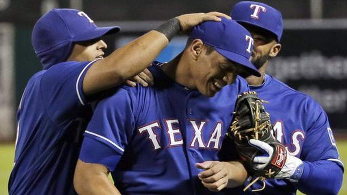 
Texas Rangers relief pitcher Keone Kela, center, is congratulated by teammates after getting out of a bases-loaded jam in his major league debut Tuesday at Oakland. Kela said he used a recently added changeup to get out of the jam. 
