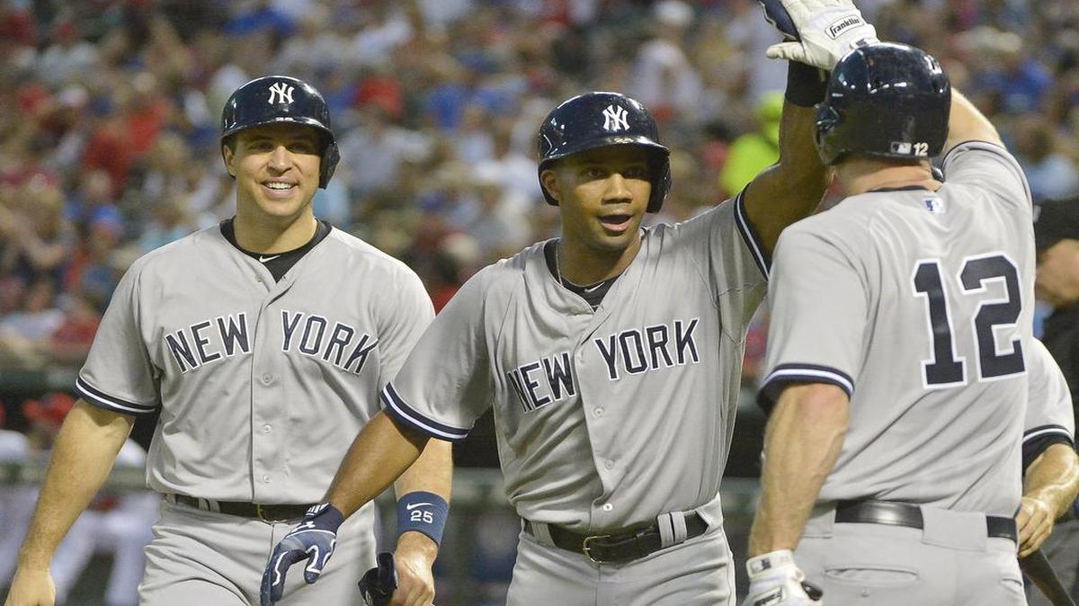 
Yankees right fielder Chris Young is congratulated by Chase Headley and Mark Teixeira after his grand slam in the third Tuesday during New York’s 21-5 win over the Rangers at Globe Life Park.
