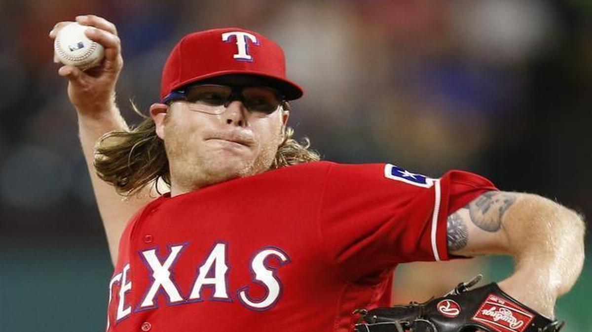 Texas Rangers starting pitcher A.J. Griffin delivers a pitch to the Cleveland Indians.