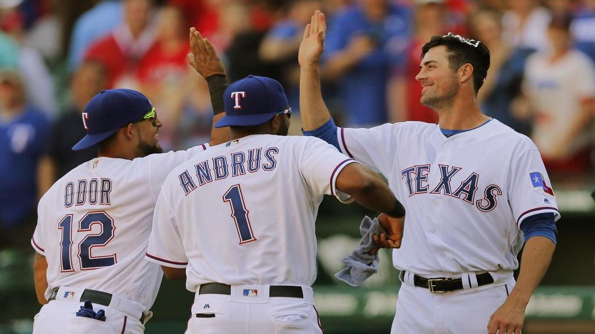 Cole Hamels, right, celebrating with Rougned Odor and Elvis Andrus, was the cream of the crop while giving up four hits in seven innings for his first Opening Day victory.