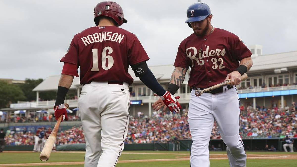 
Double A Frisco second baseman Drew Robinson, left, who leads the Texas League with 18 home runs, congratulates Josh Hamilton for scoring a run  in May. 
