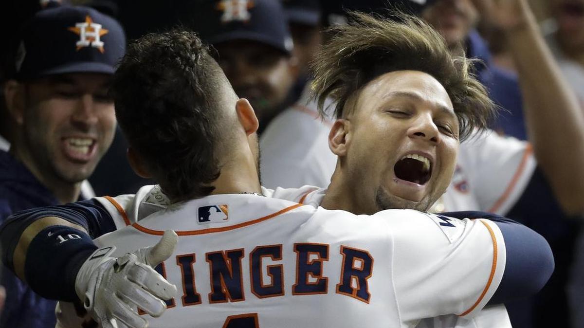 Houston Astros’ Yuli Gurriel is congratulated by George Springer after hitting a home run off Dodgers starter Yu Darvish. Later, Gurriel was captured by cameras in the dugout pulling at the corners of his eyes, mocking Darvish’s Japanese heritage. Gurriel said that wasn’t the meaning of his gesture.