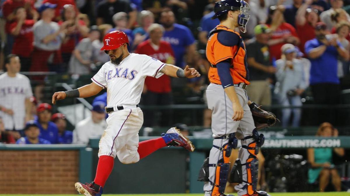 Rangers second baseman Rougned Odor scores on a double by shortstop Elvis Andrus in the sixth inning Tuesday. A season-high seven players scored a run in Tuesday’s 7-5 win.