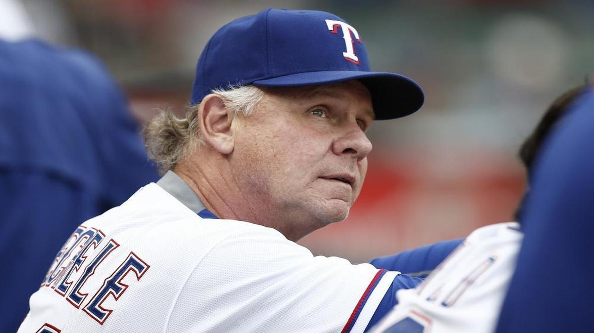 Texas Rangers bench coach Steve Buechele (24) looks on from the bench during the first inning against the Kansas City Royals. Buechele rejoined the Rangers On Monday in Seattle after watching his son, Shane Buechele start at quarterback for the Texas Longhorns on Sunday in Austin.