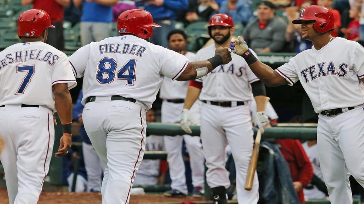 
Prince Fielder (84) is greeted at home plate by Adrian Beltre after Fielder’s two-run home run in the second inning. The Rangers piled up 11 hits in Wednesday’s 5-2 victory.


