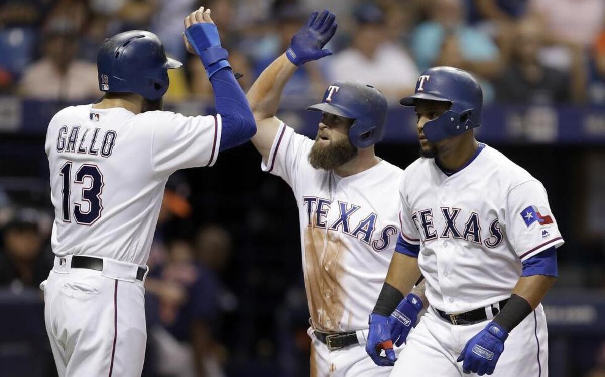 Rangers’ Mike Napoli, middle, celebrates with Joey Gallo and Carlos Gomez after Napoli’s three-run home run off Astros starter Dallas Keuchel in a six-run fourth inning for Texas.