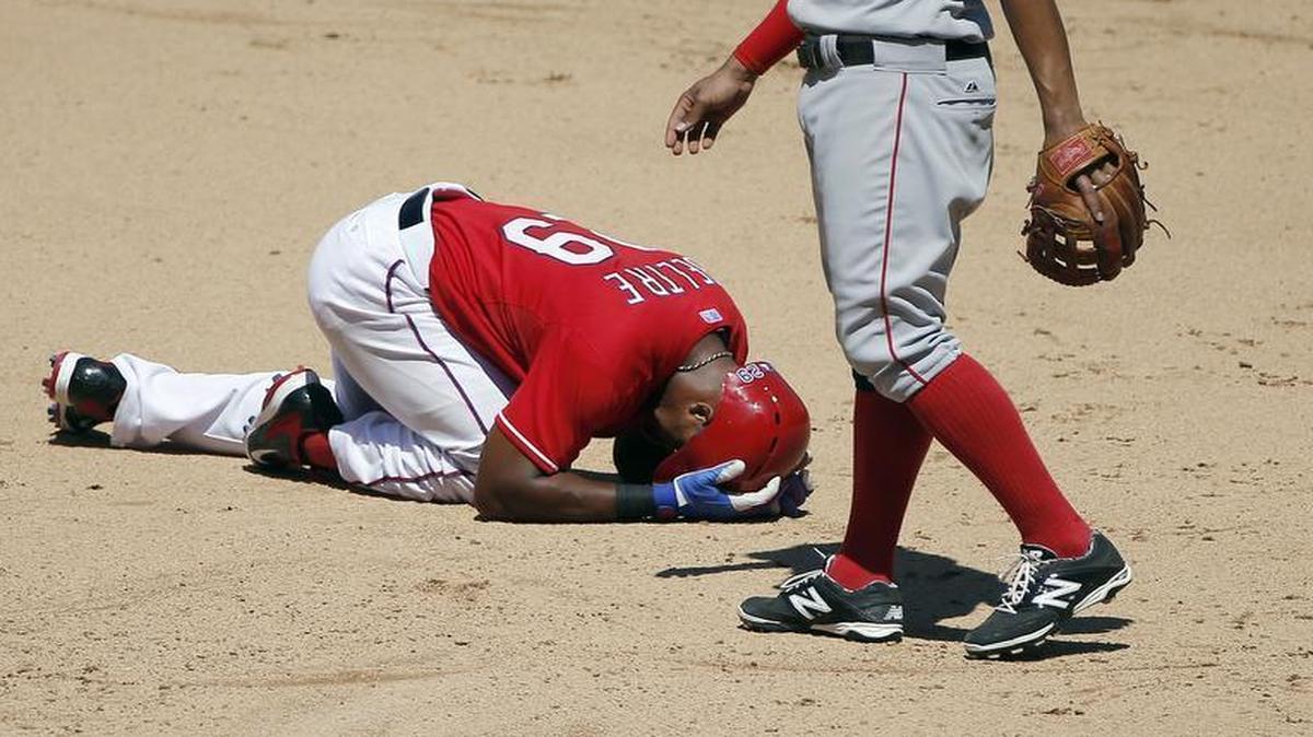 
Rangers third baseman Adrian Beltre is slow to get up after injuring his left thumb Sunday while sliding into second base.


