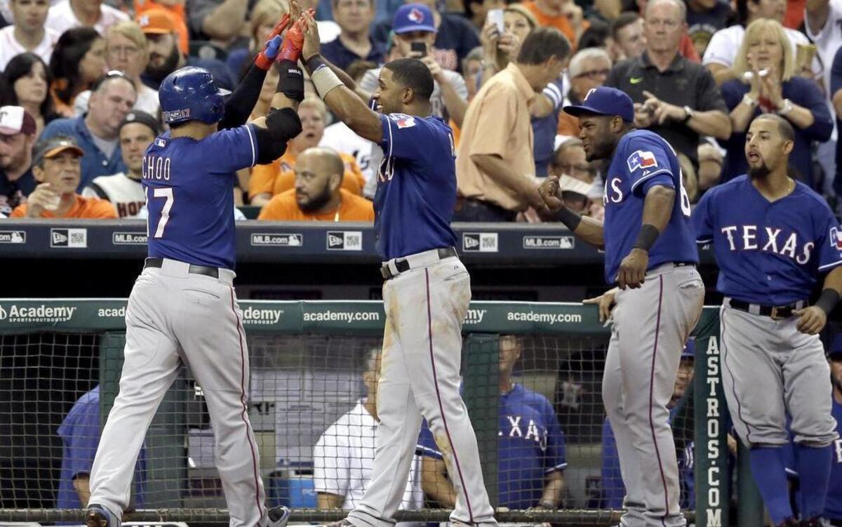 
The Rangers’ Shin-Soo Choo, left, is high-fived by Elvis Andrus, after Choo’s two-run homer in the fourth inning Friday at Minute Maid Park in Houston. Texas beat Houston 6-2 to increase its lead in the American League West to 4 1/2 games.
