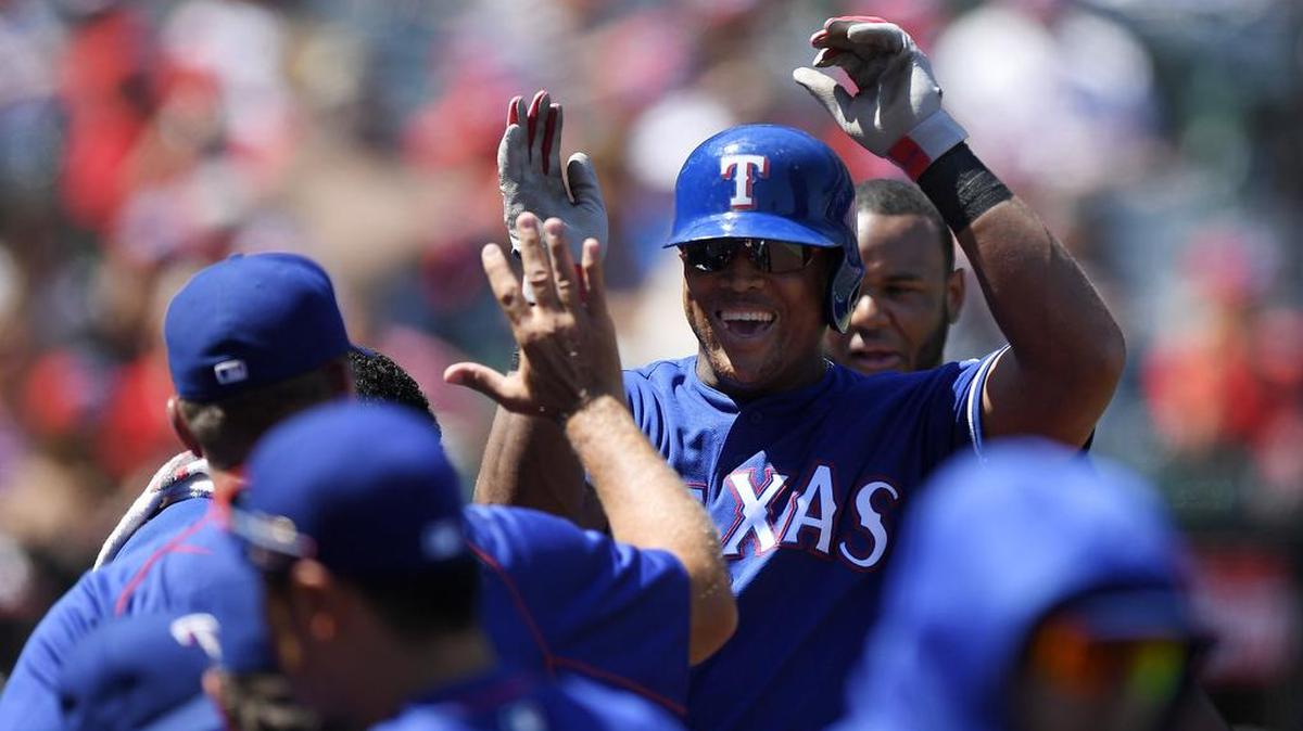 Adrian Beltre is congratulated after his first of two home runs on Sunday in the Rangers’ 3-2 loss to the Angels in Anaheim. Beltre now has 29 homers this season.