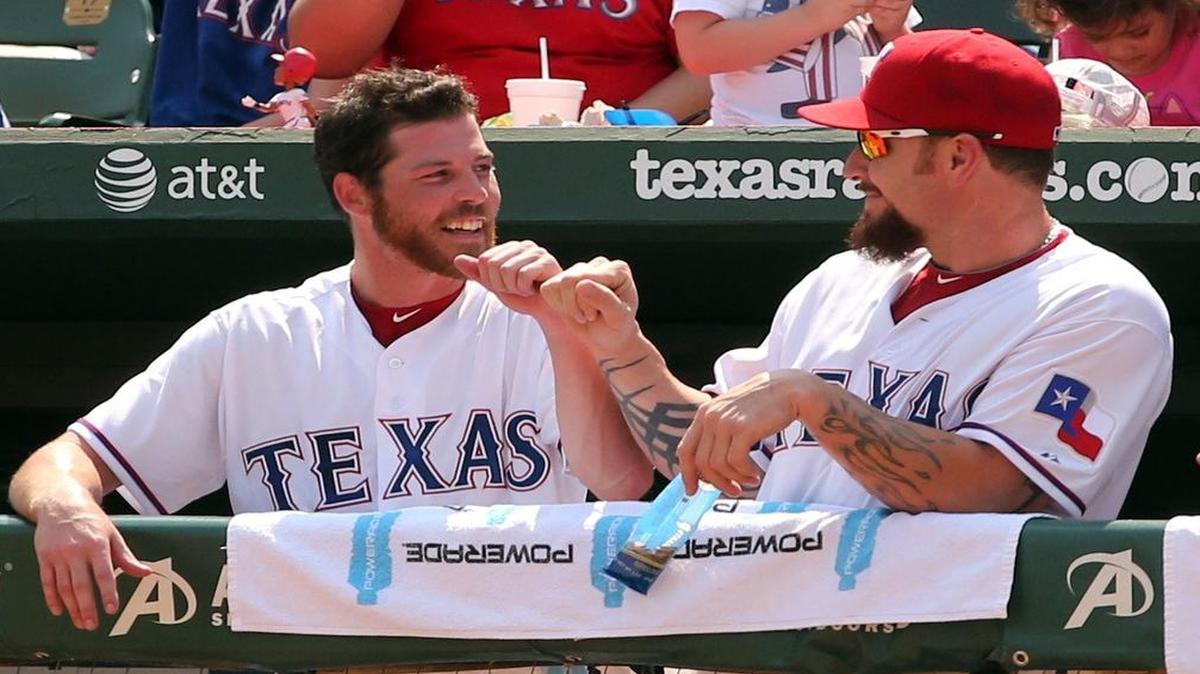 
Rangers outfielder Ryan Strausborger, left, bumps fists with Josh Hamilton in the dugout after Strausborger hit his first major league home run in the 4th inning Sunday against the Rays. Strausborger has filled in while Hamilton has nursed a sore left knee.
