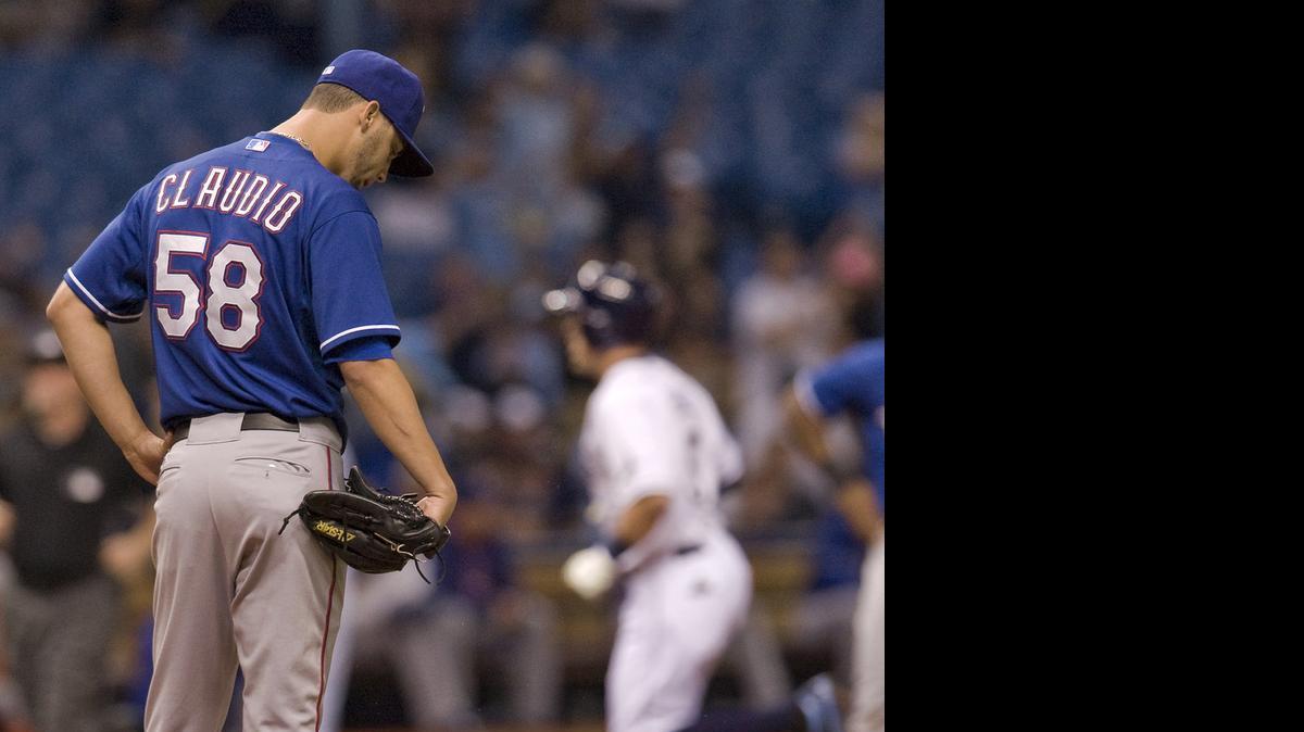 
Rangers reliever Alex Claudio, left, allowed a three-run homer to pinch-hitter Brandon Guyer in the sixth inning Friday night.


