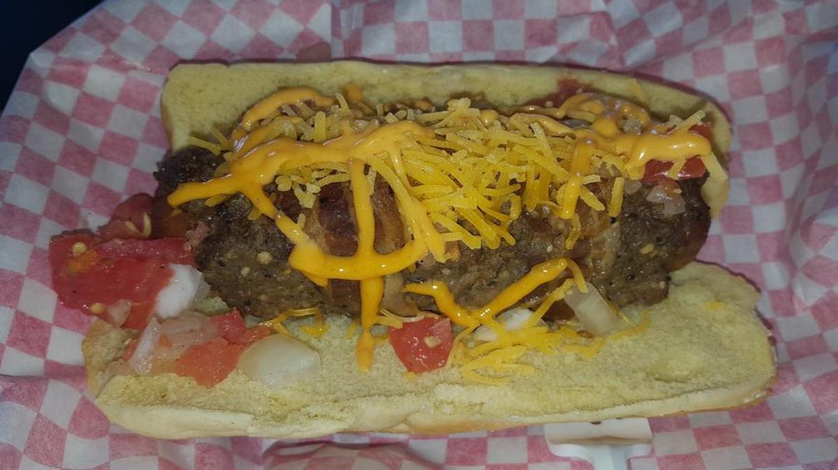 The Triple Play is a hot dog wrapped in hamburger, which is then wrapped in bacon. It’s a new, 890-calorie concession item at Surprise Stadium in Arizona, spring training home of the Rangers and Royals.
