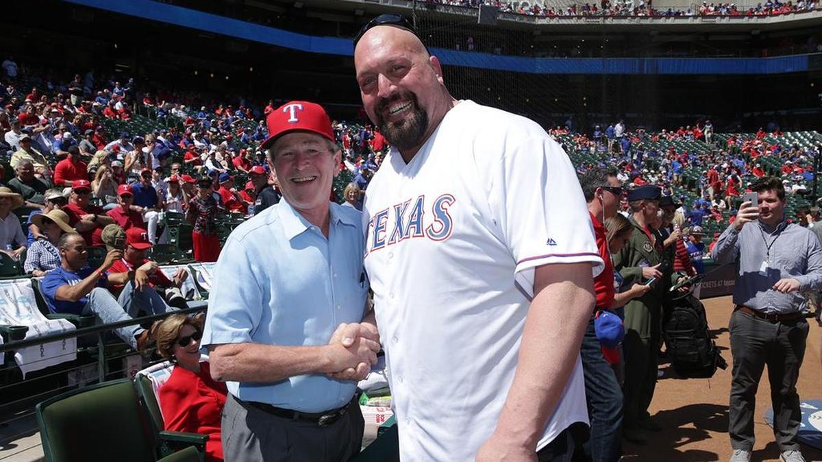Former President George W. Bush posed for photos with WWE wrestler The Big Show on Monday at Globe Life Park in Arlington.