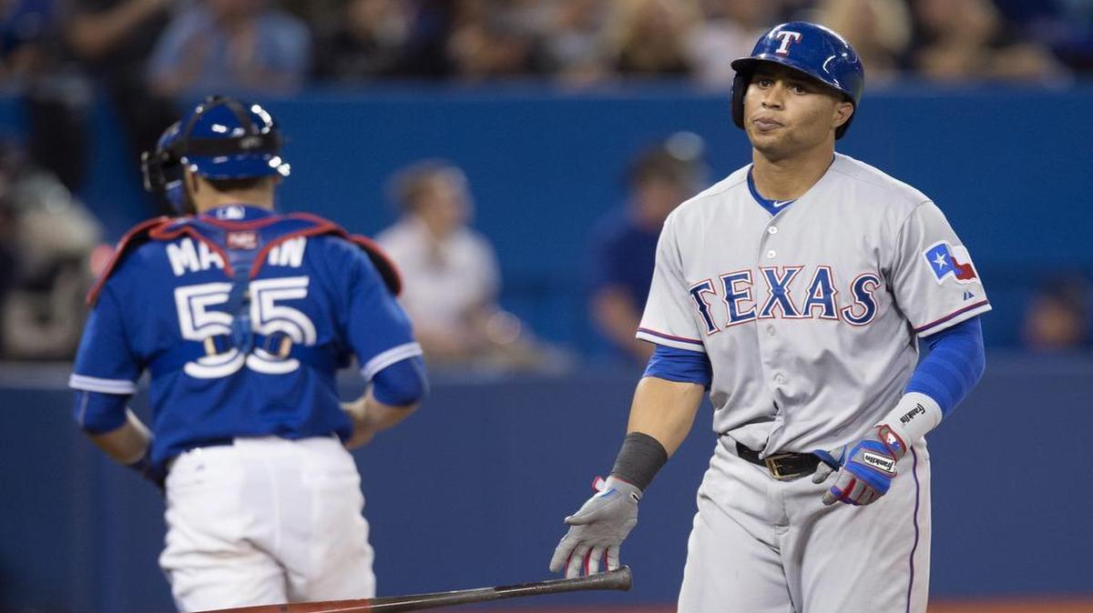 
Rangers’ center fielder Leonys Martin, right, drops his bat in front of Blue Jays catcher Russell Martin after striking out to end the sixth inning Sunday. Martin was 0 for 4 with three strikeouts and left six runners on base.
